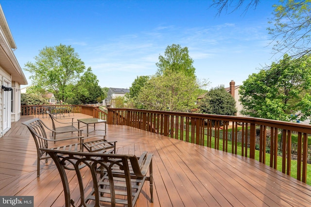 wooden terrace featuring outdoor dining area