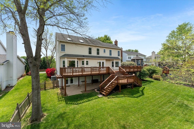 rear view of property featuring a fenced backyard, a yard, stairway, a wooden deck, and a patio area