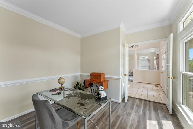 interior space with wood finished floors, crown molding, baseboards, and decorative columns