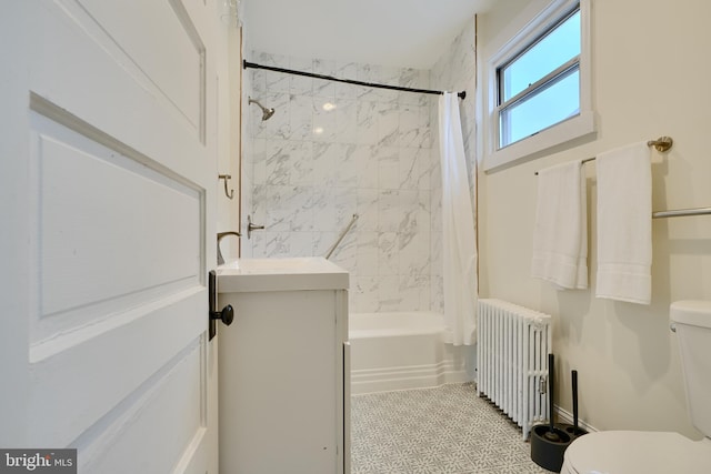 bathroom with radiator heating unit, shower / tub combo, a sink, and toilet