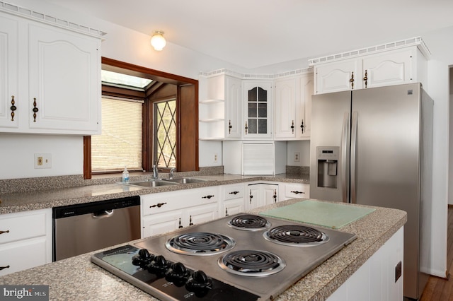 kitchen featuring open shelves, white cabinets, appliances with stainless steel finishes, light countertops, and a sink