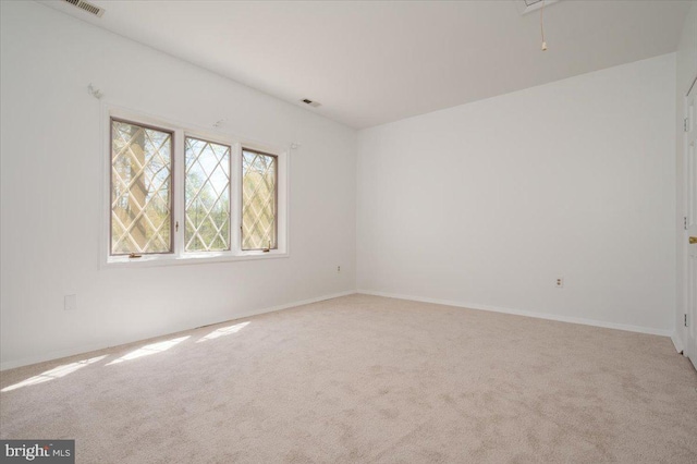 carpeted empty room with baseboards