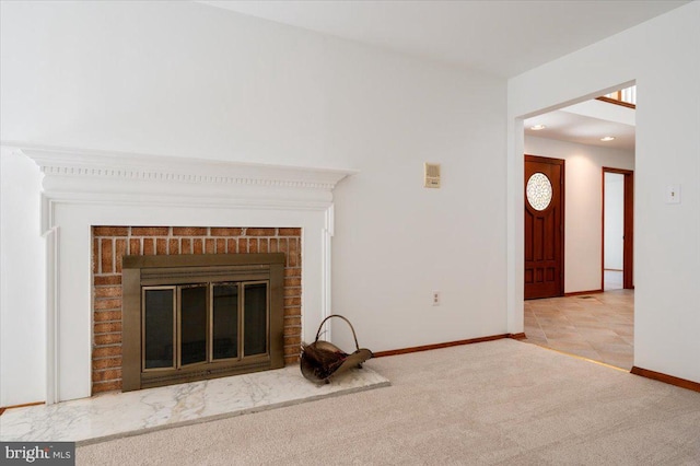 interior details featuring baseboards, carpet, and a brick fireplace