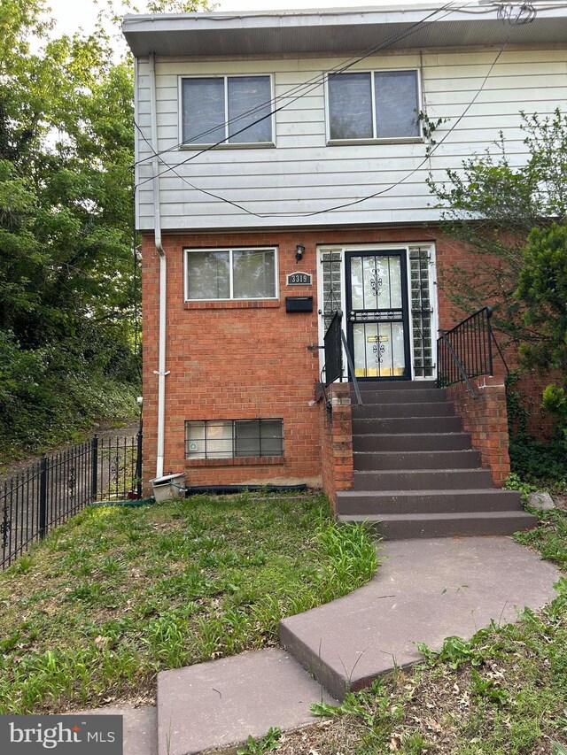 multi unit property with brick siding and fence