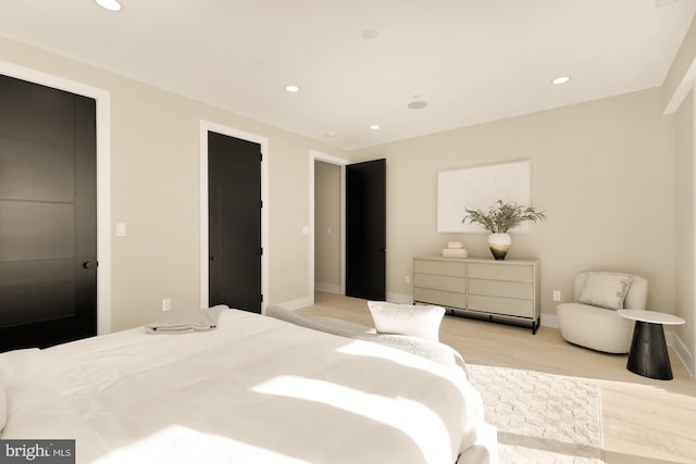 bedroom with recessed lighting, baseboards, and light wood-type flooring