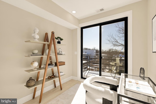 interior space with recessed lighting, baseboards, visible vents, and wood finished floors