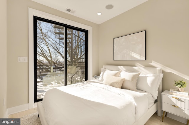 bedroom featuring baseboards, visible vents, access to exterior, and light wood-style flooring