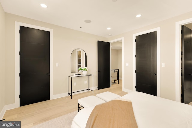 bedroom with recessed lighting, baseboards, and light wood finished floors