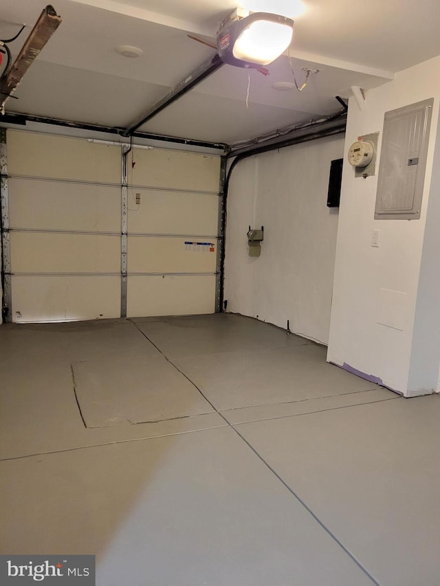 garage with electric panel and a garage door opener