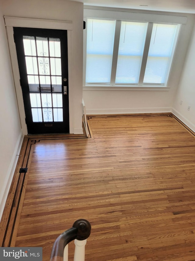 interior space featuring baseboards and wood finished floors