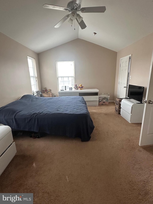 carpeted bedroom featuring lofted ceiling and a ceiling fan