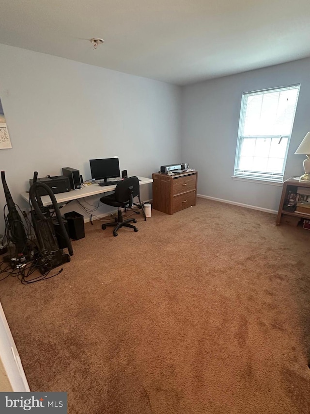 carpeted home office with baseboards