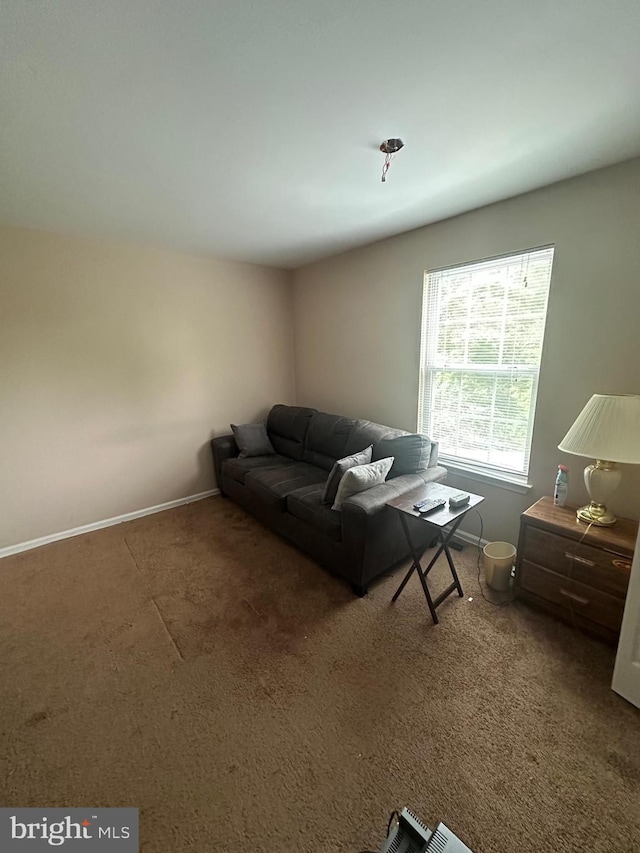carpeted living room featuring baseboards