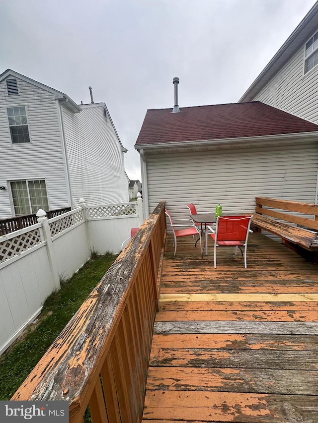 wooden deck featuring fence and outdoor dining space