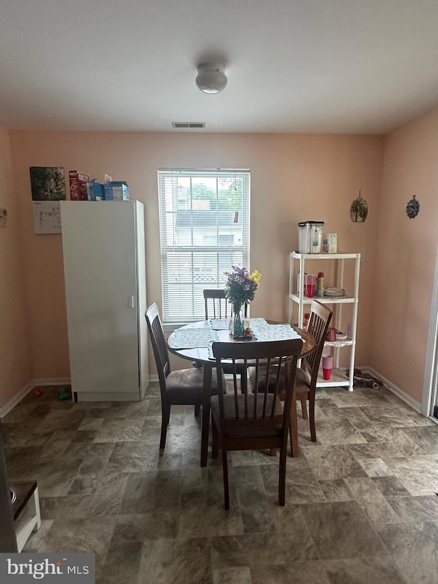 dining area featuring baseboards