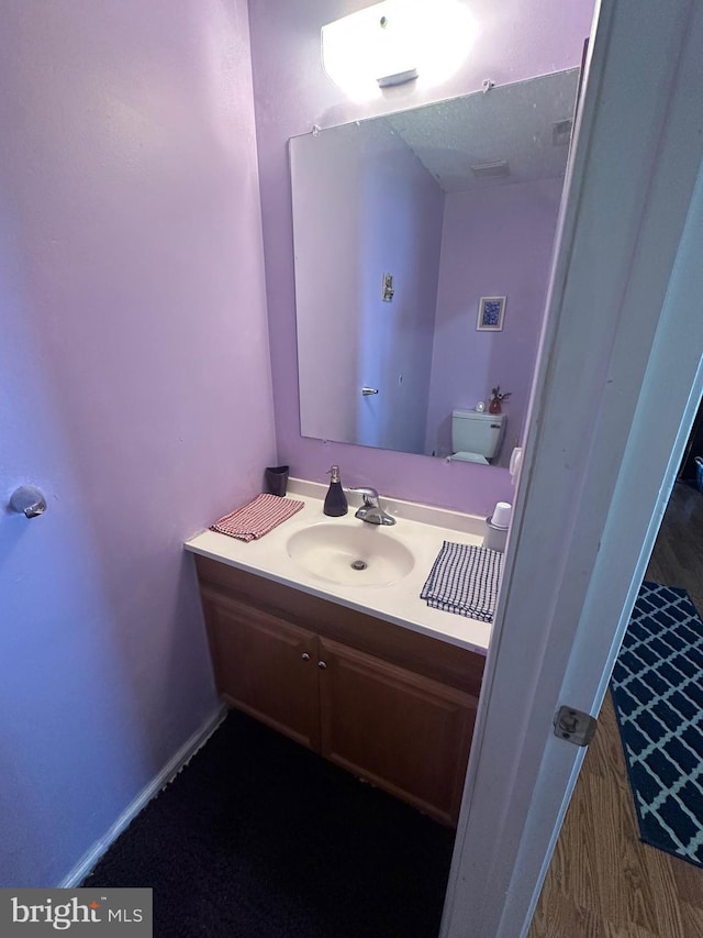 bathroom featuring vanity and toilet