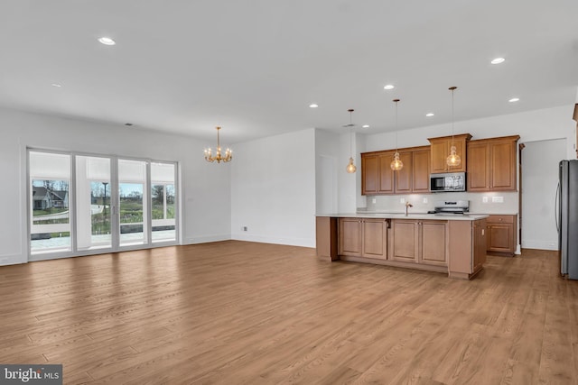85 Quiet Creek Dr, Gettysburg, PA 17325 - kitchen with an inviting chandelier, light wood-style flooring, recessed lighting, light countertops, and stainless steel appliances