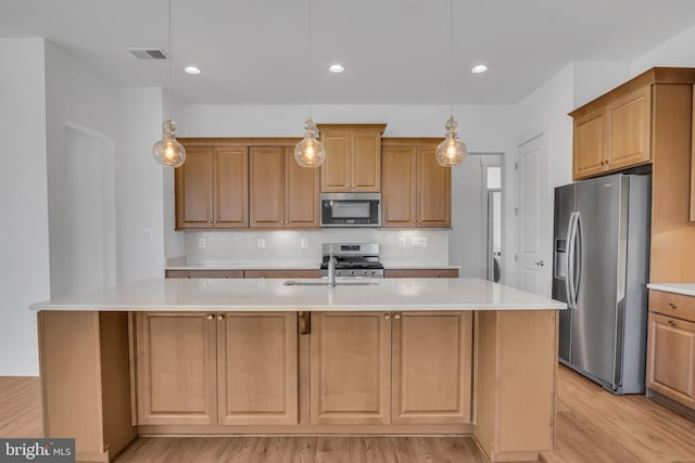 85 Quiet Creek Dr, Gettysburg, PA 17325 - kitchen featuring light wood-style floors, an island with sink, visible vents, appliances with stainless steel finishes, and light countertops