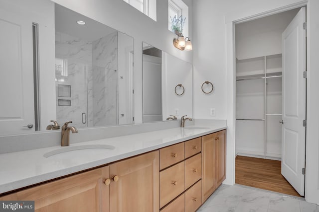 85 Quiet Creek Dr, Gettysburg, PA 17325 - bathroom featuring a sink, double vanity, a walk in closet, a marble finish shower, and marble finish floor