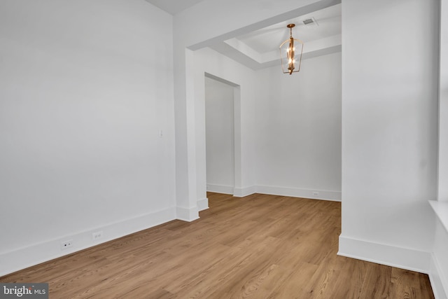 85 Quiet Creek Dr, Gettysburg, PA 17325 - spare room featuring a tray ceiling, light wood finished floors, visible vents, and baseboards