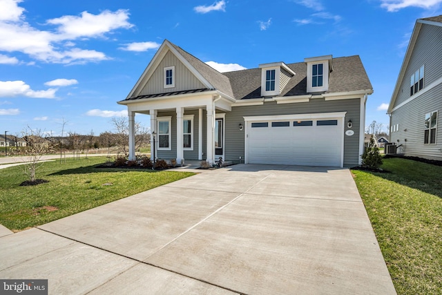 85 Quiet Creek Dr, Gettysburg, PA 17325 - view of front of home featuring concrete driveway, a front yard, board and batten siding, and a garage