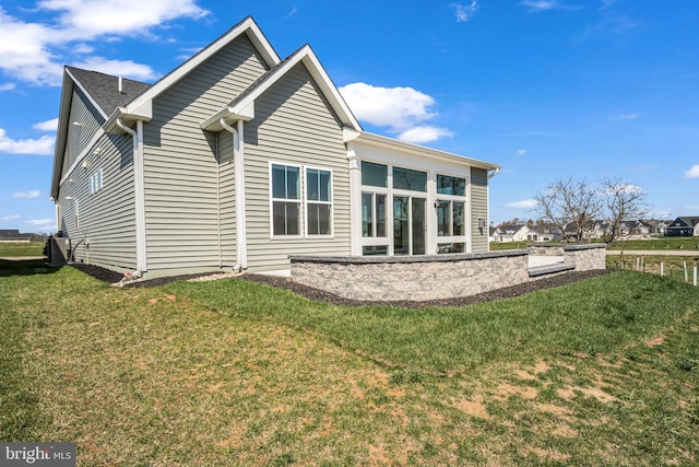 85 Quiet Creek Dr, Gettysburg, PA 17325 - back of property featuring central air condition unit, a sunroom, and a lawn