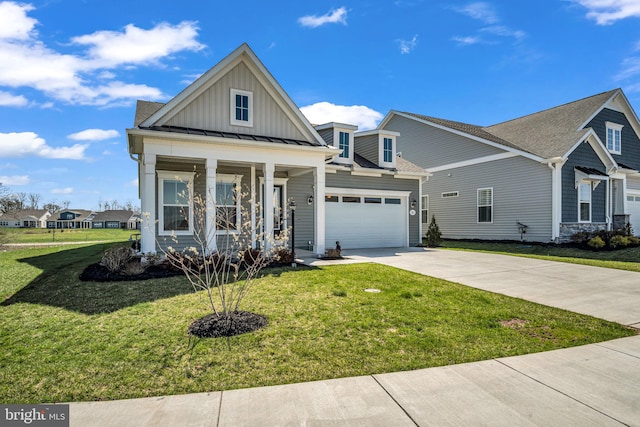85 Quiet Creek Dr, Gettysburg, PA 17325 - view of front of home featuring a front yard, an attached garage, board and batten siding, concrete driveway, and a standing seam roof