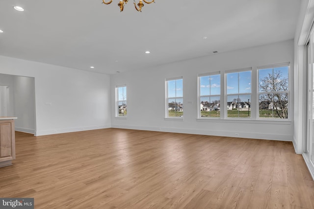85 Quiet Creek Dr, Gettysburg, PA 17325 - unfurnished living room with recessed lighting, light wood-style flooring, baseboards, and an inviting chandelier