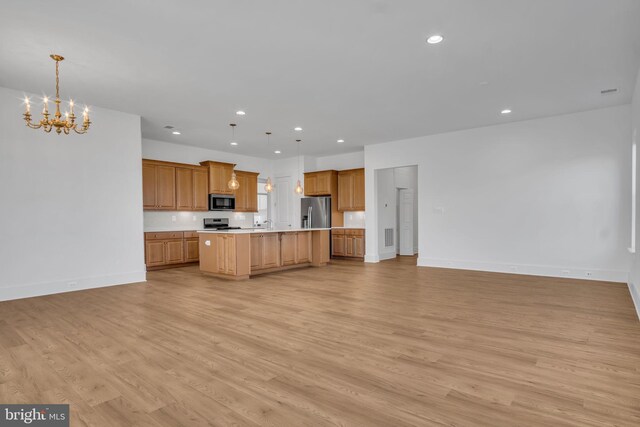 85 Quiet Creek Dr, Gettysburg, PA 17325 - kitchen featuring a notable chandelier, open floor plan, light countertops, light wood-type flooring, and appliances with stainless steel finishes