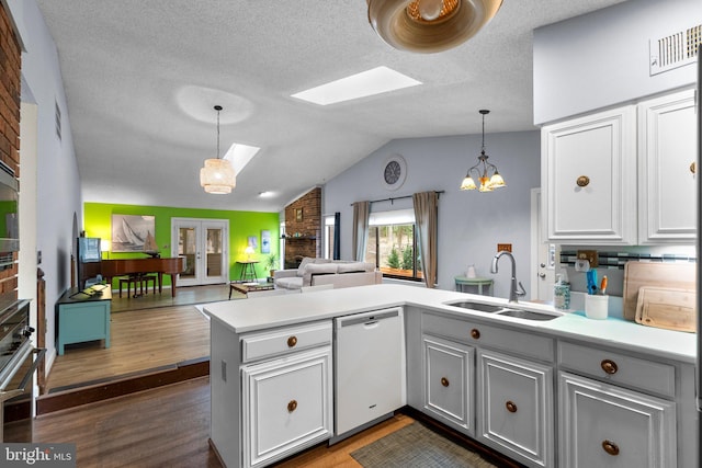 2200 Harpoon Dr, Stafford, VA 22554 - kitchen featuring a sink, dishwasher, a skylight, a peninsula, and light countertops