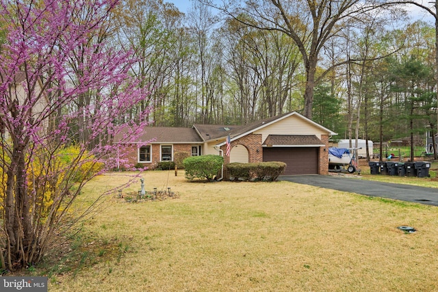2200 Harpoon Dr, Stafford, VA 22554 - view of front of house featuring a garage, brick siding, driveway, and a front lawn