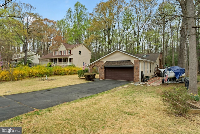 2200 Harpoon Dr, Stafford, VA 22554 - view of front of house with brick siding, a front lawn, and asphalt driveway