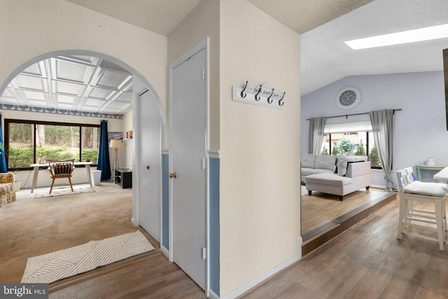 2200 Harpoon Dr, Stafford, VA 22554 - corridor with arched walkways, wood finished floors, vaulted ceiling, and baseboards