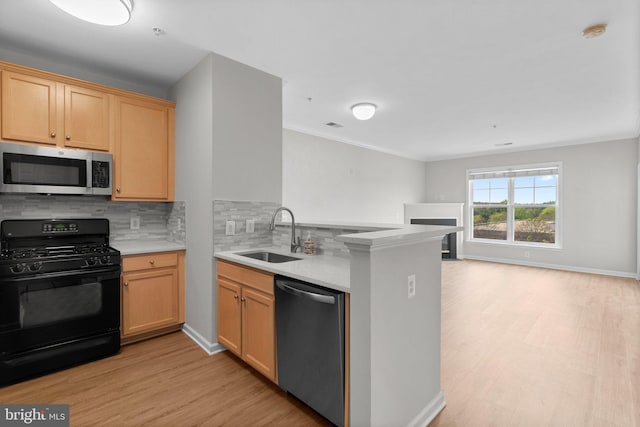 3830 Lightfoot St Unit 335, Chantilly, VA 20151 - kitchen featuring backsplash, a sink, a peninsula, light wood finished floors, and stainless steel appliances