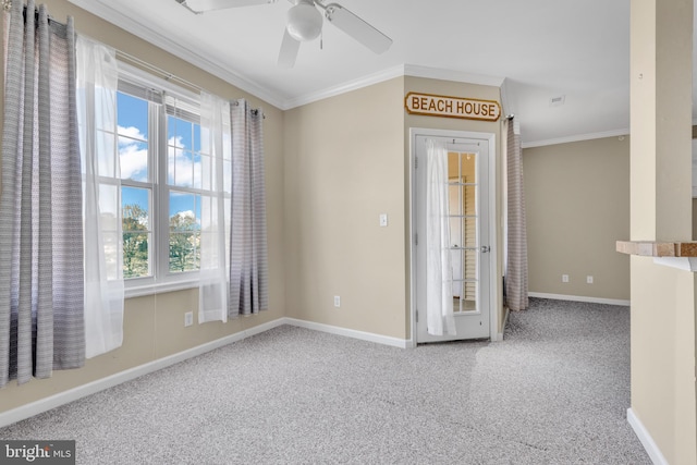 carpeted empty room featuring crown molding, baseboards, plenty of natural light, and ceiling fan