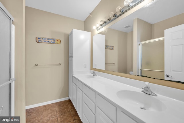 bathroom featuring visible vents, double vanity, baseboards, an enclosed shower, and a sink
