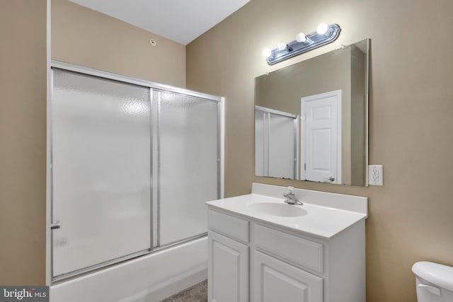 full bath featuring vanity, enclosed tub / shower combo, and toilet
