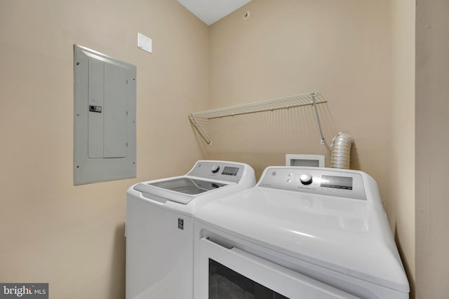 washroom with washer and dryer, laundry area, and electric panel