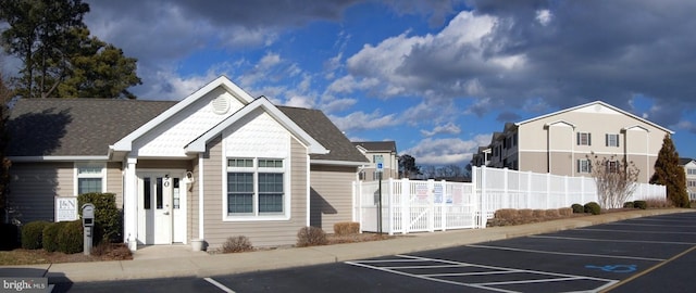 exterior space with fence and uncovered parking