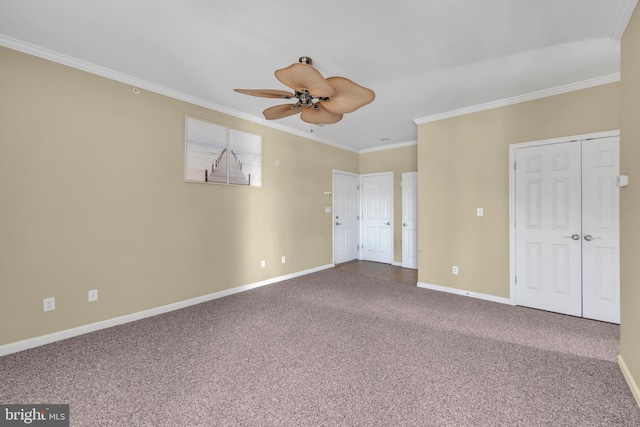 unfurnished bedroom with crown molding, a ceiling fan, baseboards, and carpet floors