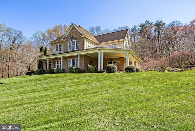 view of front facade with a front yard and brick siding