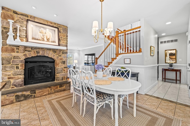 dining room featuring stairs, tile patterned flooring, a notable chandelier, and a wainscoted wall