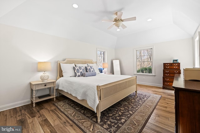 bedroom featuring ceiling fan, recessed lighting, hardwood / wood-style floors, lofted ceiling, and baseboards