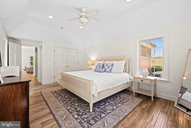 bedroom with recessed lighting, wood-type flooring, baseboards, and lofted ceiling