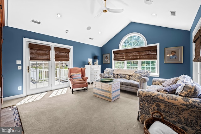 living area with carpet, lofted ceiling, a ceiling fan, and visible vents