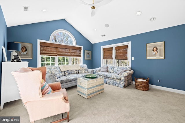 carpeted living room featuring high vaulted ceiling, visible vents, baseboards, and a ceiling fan