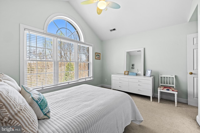 carpeted bedroom with high vaulted ceiling, visible vents, baseboards, and a ceiling fan