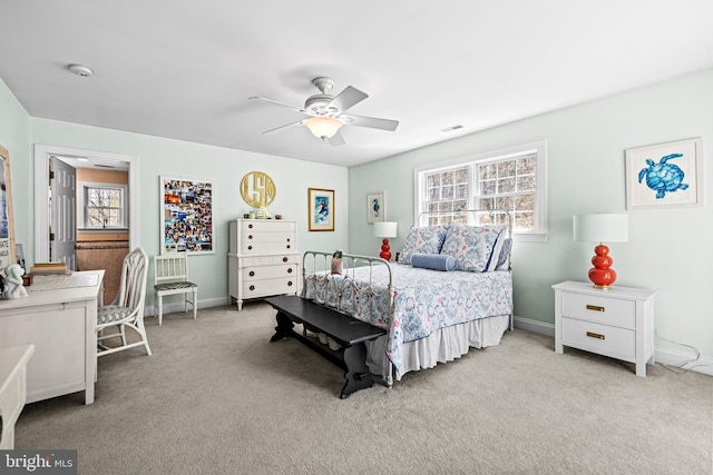 carpeted bedroom featuring visible vents, baseboards, and a ceiling fan