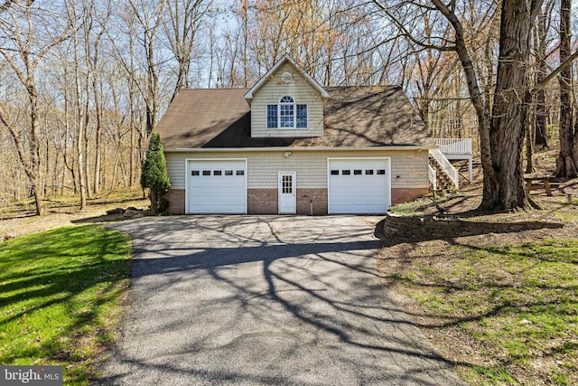 detached garage featuring driveway
