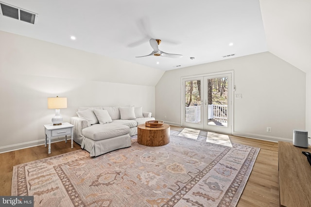 living area with a ceiling fan, visible vents, wood finished floors, lofted ceiling, and baseboards